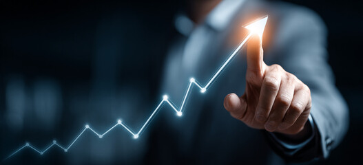 Businessman touching a glowing upward arrow graph symbolizing business growth, success, and financial progress

