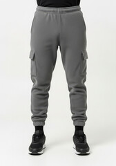 Front view of a person in gray fleece cargo pants black socks and sneakers on a white backdrop