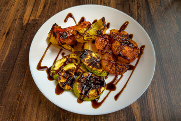 Different baked vegetables poured with soy sauce on dish
