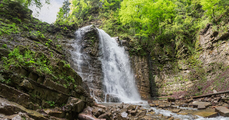 Maniava waterfall falling from precipitous cliff ledge in Ukrainian Carpathians
