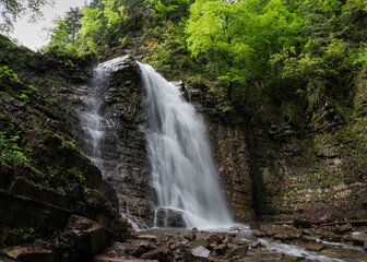 Maniava waterfall falling from precipitous cliff ledge in Ukrainian Carpathians