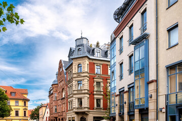 Urban scene in Weimar with shopfronts, historic residential buildings on a sunny day in summer