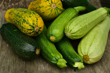 zucchini on the market. Autumnal harvest squash and zucchini variety on wooden background. Harvesting zucchini. Fresh organic vegetables, rustic background.