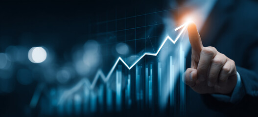 Businessman touching a glowing upward arrow graph symbolizing business growth, success, and financial progress

