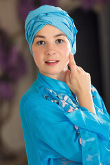 Portrait young woman in oriental blue dress. Eastern dance.