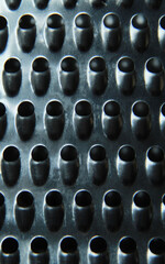closeup of kitchen metal grater with holes texture