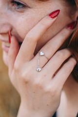 Silver Heart Chain Ring on Woman&rsquo;s Hand Close-Up