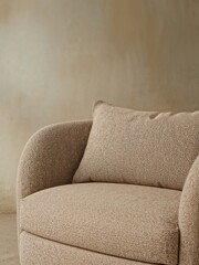 Modern Beige Armchair with Textured Fabric and Cushion Detail against a Neutral Wall Minimalist Home Decor
