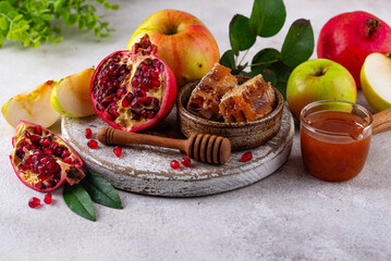 Rosh Hashana concept with honey, apple and pomegranate