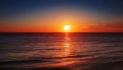 vivid red sunset over calm ocean waters with sun s reflection creating a serene and tranquil seascape during evening