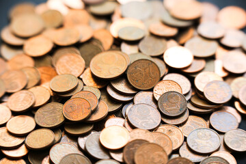Close-up of a large scattered pile of copper euro cent coins, featuring 1, 2, and 5 cent denominations. European currency in warm tones, illustrating small change, savings, and finance concepts