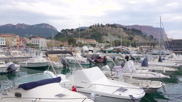 Boats in Cassis France Tied in the Marina Tilt Up on a Summer Day with Castle Mountain in Background in Port, Harbor, Dock