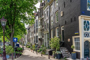 Details and facades of Amsterdam characteristic brick construction of residential building in Amsterdam School style. High quality photo