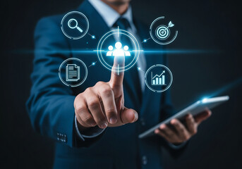 Businessman interacting with digital interface and holographic icons representing business analytics and strategy