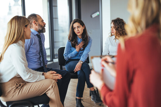 Group Therapy Session with Participants Sharing and Listening in an Office Setting