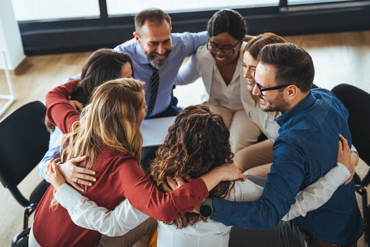 Diverse Team Embracing in Circle Depicting Unity and Collaboration