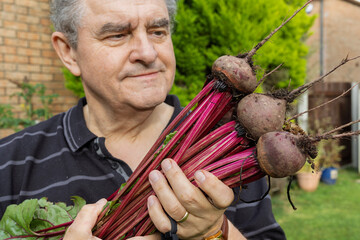 Close-Up of Man Admiring Fresh Beetroot Harvest