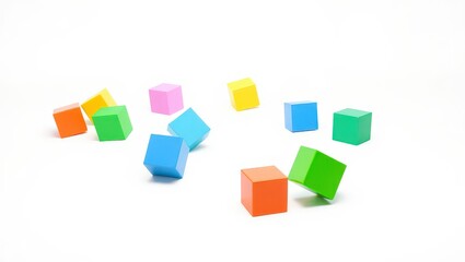 Obraz premium Scattered colorful wooden toy cubes on a white surface creating a playful and minimalist composition