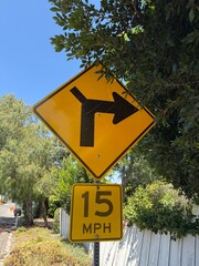 Right Turn Ahead Sign: Traffic sign indicating a right turn with a recommended speed limit of 15 MPH for safe navigation
