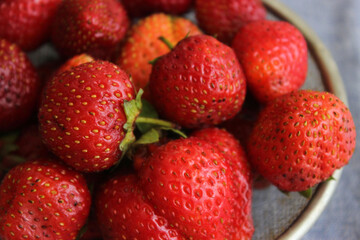 Strawberries in a sieve on a table