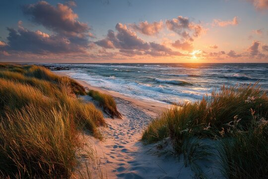Path to the ocean at dusk with grassy dunes and a wooden fence leading to the sandy beach during a colorful sunset
