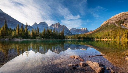 stunning mountain landscape with a clear alpine lake snow covered hills in the background captured from a droners aerial perspective
