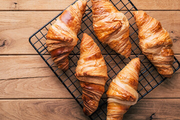 fresh croissants on wooden background