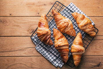 fresh croissants on wooden background