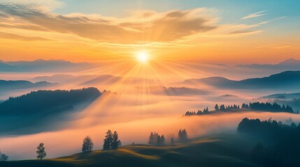 Sun shining through fog over rolling hills at sunrise