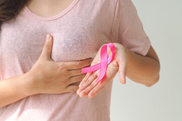healthcare and medicine concept. Woman hand holding pink breast cancer awareness ribbon.