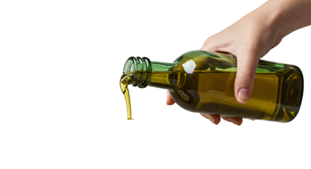 Hand pouring olive oil from a green glass bottle with a stream of oil against black background on transparent background