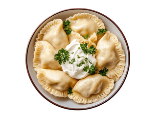Delicious plate of traditional pierogi dumplings garnished with sour cream and fresh parsley transparent background