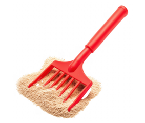 Red toy rake on a bed of sand against a transparent background perfect for play
