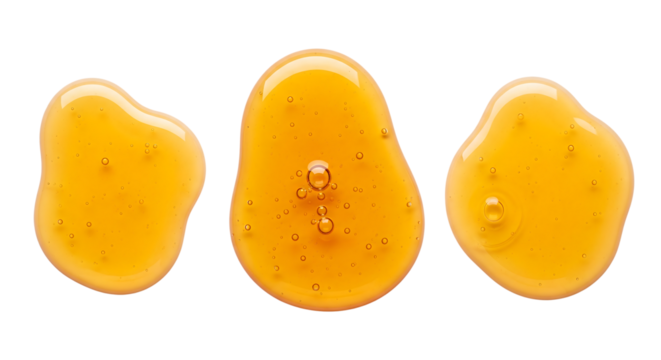 Three golden honey drops or cosmetic serum blobs with bubbles. Isolated on transparent background, png
