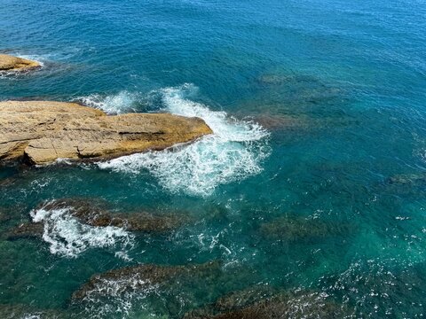 Aerial view turquoise Mediterranean sea stormy waves and rocky coast.