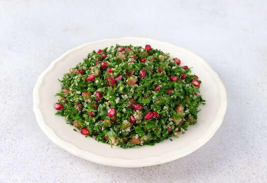 Levantine vegetarian Tabbouleh salad with quinoa, tomatoes, pomegranate, parsley, lemon and dressing