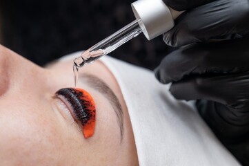 The process of professional lamination and tinting of eyelashes in the salon.
