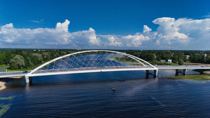 Obraz premium Modern White Rääma Arch Bridge Over Pärnu River - Aerial View, Estonia