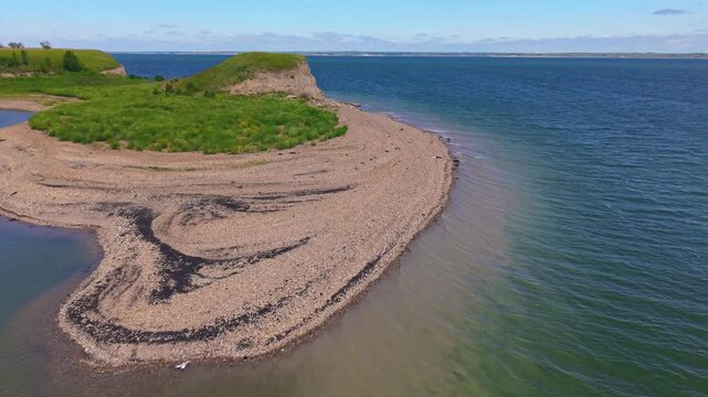 A breathtaking aerial view captures the expansive shoreline of Lake Sakakawea at sunset