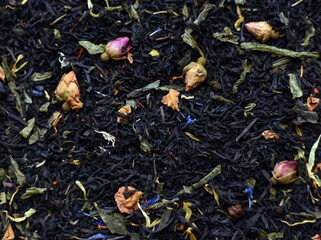 Black tea with spices and herbs boost immunity.Dry black and green tea. Top view. Pile of leaves. Herbal tea background.
