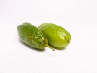 Fresh green bilimbi fruit, also known as Averrhoa bilimbi or belimbing wuluh, isolated on white background. Commonly used in Southeast Asian cuisine and traditional medicine.