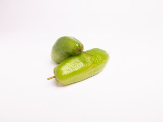 Fresh green bilimbi fruit, also known as Averrhoa bilimbi or belimbing wuluh, isolated on white background. Commonly used in Southeast Asian cuisine and traditional medicine.