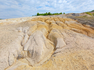Tailings and waste sand  in  mined open pit coal quarry. Heavy erosion