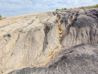 Tailings and waste sand  in  mined open pit coal quarry. Heavy erosion