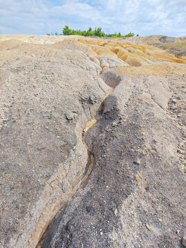 Tailings and waste sand  in  mined open pit coal quarry. Heavy erosion