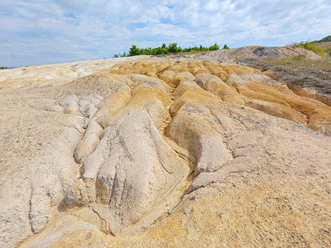 Tailings and waste sand  in  mined open pit coal quarry. Heavy erosion