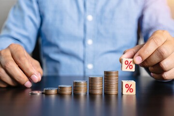 Growing Coin Stack with Percent Sign Blocks - Financial Growth Concept