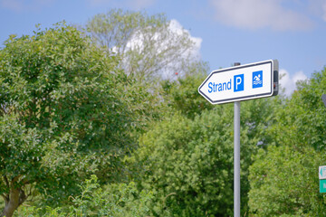 Directional Sign to Beach and Parking with Nature Background