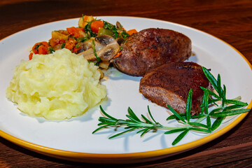Deer steak with mushroom-vegetable ragout and mashed potatoes