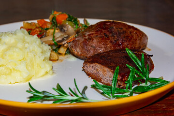 Deer steak with mushroom-vegetable ragout and mashed potatoes